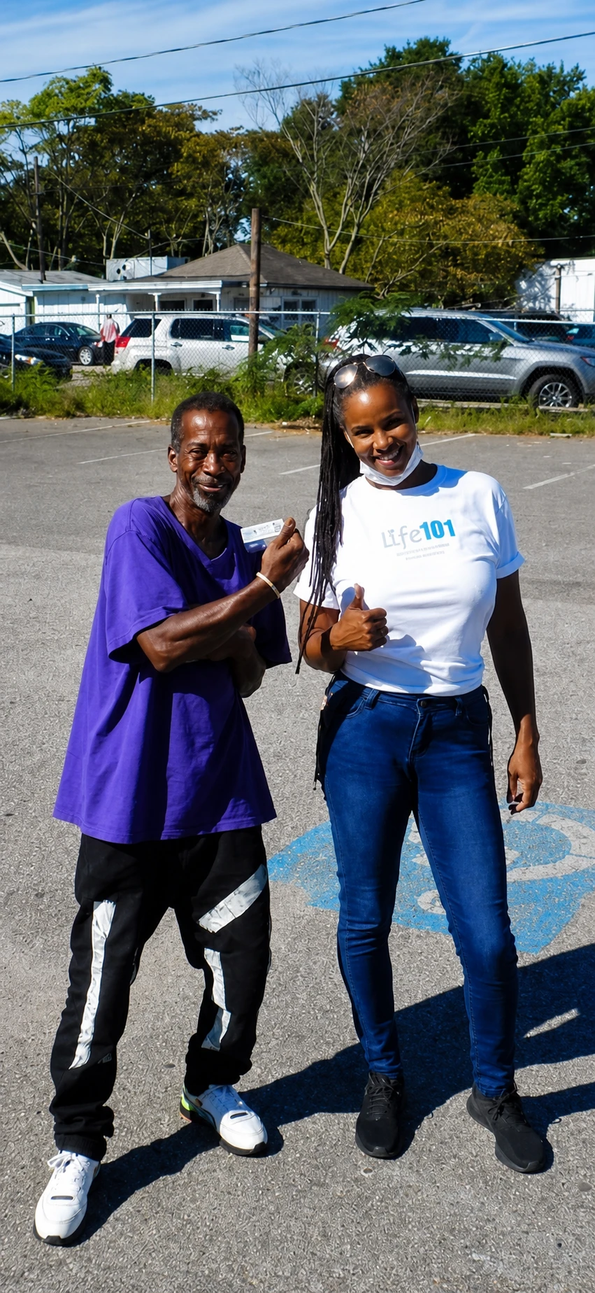 A small group of young adults and a mentor gathered together, smiling
